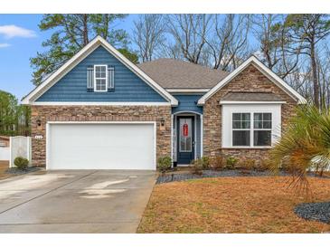 Charming single Gathering home with stone accents, blue siding, and a well manicured lawn at 414 Antietam Place, Little River, SC 29566