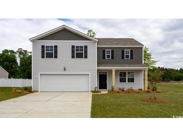 Charming two-story home featuring a two-car garage, gray siding, and a well-manicured lawn at 815 Green Garden Way, Myrtle Beach, SC 29579