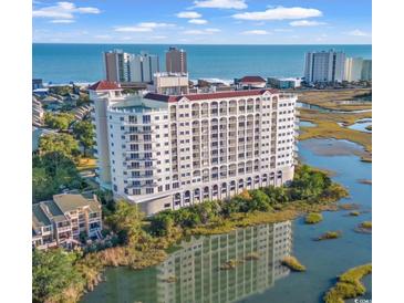 Beautiful exterior view of the building overlooking a marsh and the ocean at 9547 Edgerton Dr. # 204, Myrtle Beach, SC 29572