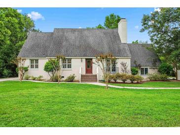 Charming single-story home with lush green lawn, brick entryway, and well-maintained landscaping at 966 Waterway Ln., Myrtle Beach, SC 29572