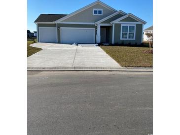 Charming one-story home with a two-car garage and a well-manicured lawn at 171 Glengrove Lane, Murrells Inlet, SC 29576