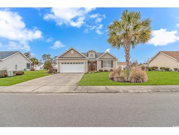 Charming single-story home boasting a well-manicured lawn, attached garage, and beautiful landscaping at 401 Oak Crest Circle, Longs, SC 29568