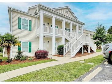 Charming two-story condo featuring white columns and a beautiful staircase leading to the entrance at 4905 Britewater Ct. # 202, Myrtle Beach, SC 29579