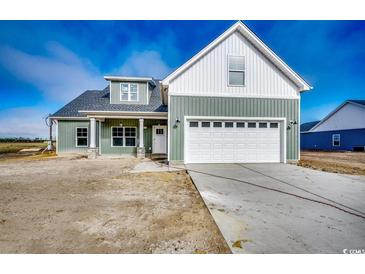 Charming two-story home with white siding, attached two car garage and covered entry at 4975 Dupont Rd., Conway, SC 29526