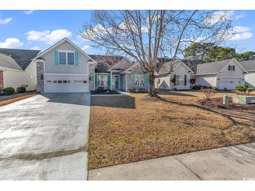 Charming single Gathering home features a spacious front yard, welcoming curb appeal, and an attached two-car garage at 537 Sand Ridge Rd., Conway, SC 29526