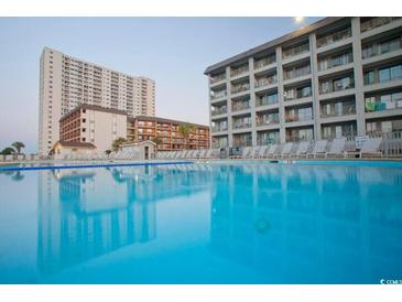 Resort-style pool with clear blue water surrounded by multiple story condo buildings at 5905 S Kings Hwy. # 327 A, Myrtle Beach, SC 29575