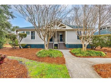 Charming single-story home with well-maintained landscaping and inviting front entrance at 65 Lakeside Dr. # 65A, Pawleys Island, SC 29585