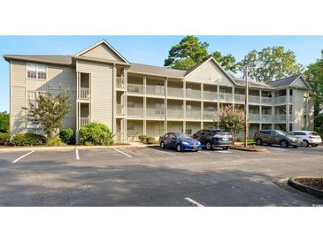 Attractive condo building with multiple levels and balconies, surrounded by well-maintained landscaping at 922 Fairwood Lakes Ln. # 22M, Myrtle Beach, SC 29588