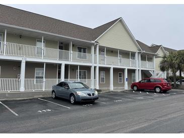 Two-story condo building with white railings and two parked cars at 113 Butkus Dr. # 3, Myrtle Beach, SC 29588