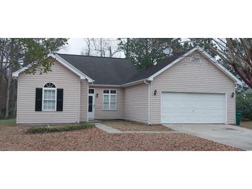 Charming home featuring a one-car garage and a well-maintained, tidy front yard landscape at 134 Clovis Circle, Myrtle Beach, SC 29579