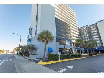 Street-level view of Bluewater Resort featuring palm trees and well-maintained landscaping at 2001 S Ocean Blvd. # 405, Myrtle Beach, SC 29577