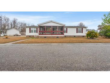 Charming single-story home with a screened-in porch and well-maintained lawn at 287 Kanawha Trail, Longs, SC 29568