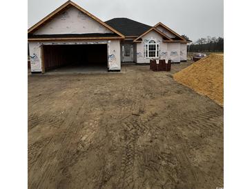 New home construction featuring a two-car garage, covered entrance, and attractive architectural details at 3424 Asbury Rd., Aynor, SC 29511