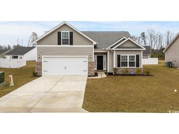 Charming single-story home features a two-car garage and well-maintained landscaping at 349 Lakota Loop, Longs, SC 29568