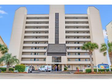 Beige exterior of the Water Pointe II Condo in Myrtle Beach, South Carolina with a glimpse of palm trees on a partly cloudy day at 4111 Ocean Blvd. S # 402, North Myrtle Beach, SC 29582