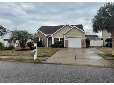 Charming single-story home with a well-manicured lawn and a two-car garage at 422 Cassian Way, Myrtle Beach, SC 29588