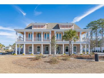 Stunning two-story townhome with double balconies, brick accents, and a well-manicured front yard at 8035 Arcady St. # B, Myrtle Beach, SC 29572