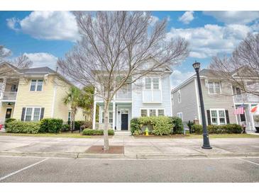 Charming two-story home with a balcony and well-manicured landscaping, creating a welcoming curb appeal at 843 Howard Ave., Myrtle Beach, SC 29577