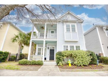 Charming two-story home features a welcoming double porch, lush landscaping and classic architectural details at 843 Howard Ave., Myrtle Beach, SC 29577