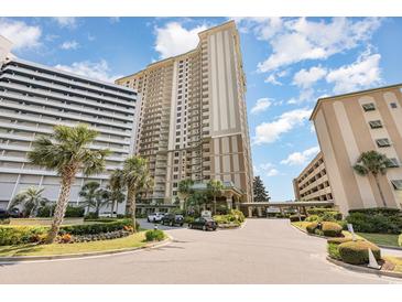 Lovely exterior of a high-rise condo building showing well-kept grounds and convenient covered drop-off at 9994 Beach Club Dr. # 1601, Myrtle Beach, SC 29572