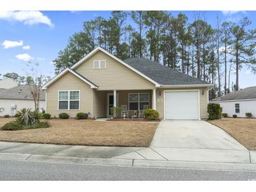 Charming single-story home featuring a well-manicured lawn, attached garage, and cozy front porch with rocking chairs at 1222 Midtown Village Dr., Conway, SC 29526