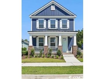 Charming two-story home with a welcoming front porch and beautiful blue siding at 1800 Tryon Dr, Myrtle Beach, SC 29588