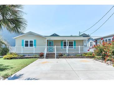 Charming single-story beach home with a cozy front porch, well-manicured lawn, and ample parking space at 317 23Rd Ave. N, North Myrtle Beach, SC 29582