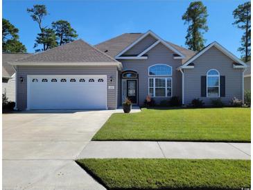 Charming single-story home featuring a two-car garage, well-manicured lawn, and inviting front entrance at 372 Leste Rd., Myrtle Beach, SC 29588