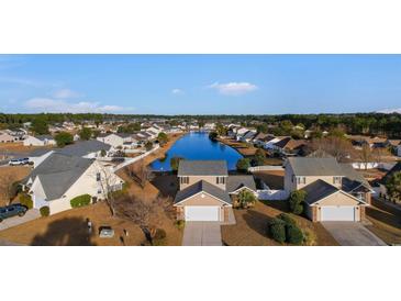 Beautiful aerial view of homes on a lake in a well maintained community on a sunny day at 4387 Heartwood Ln., Myrtle Beach, SC 29579