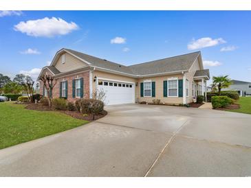 Charming single-story home with manicured lawn, long driveway and an attached two-car garage at 446 Deerfield Links Dr., Surfside Beach, SC 29575