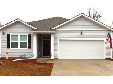 Charming single-story home with gray siding, attached garage, and well-manicured landscaping at 583 Meadowgrass Ct., Myrtle Beach, SC 29588