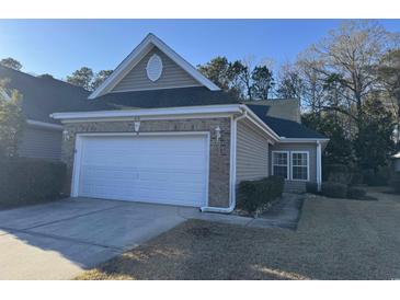 Charming single-story home featuring a two-car garage, brick accents, and well-maintained landscaping at 672 Pinehurst Ln. # 81D, Pawleys Island, SC 29585