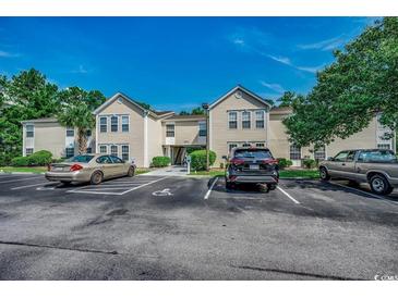 Inviting two-story condo exterior featuring well-maintained landscaping and convenient parking at 8545 Hopkins Circle # G, Myrtle Beach, SC 29575