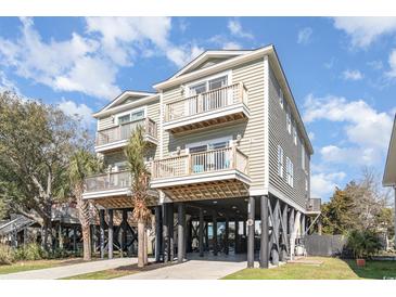 Inviting raised beach home featuring double balconies and a spacious underneath parking area at 124 B Vista Dr., Murrells Inlet, SC 29576