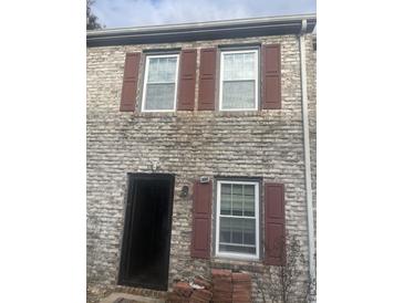 Two-story brick home featuring red shutters and white trimmed windows at 1506 Haven Dr. # H, North Myrtle Beach, SC 29582