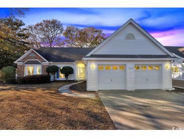 Charming one-story home featuring a brick facade, two-car garage and well-maintained landscaping at 1639 Coventry Rd., Surfside Beach, SC 29575