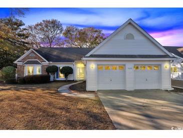 Charming single-story home with a two-car garage and well-maintained landscaping at 1639 Coventry Rd., Surfside Beach, SC 29575
