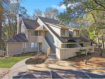 Charming condo with grey siding, mature trees, and inviting walkway to the front entry at 222 Westleton Dr. # 18D, Myrtle Beach, SC 29572