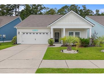 Charming single-story home featuring a well-manicured lawn and a welcoming front porch at 2568 Goldfinch Dr., Myrtle Beach, SC 29577