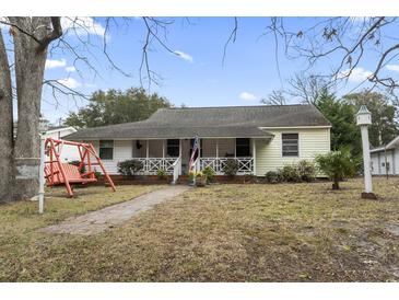 Charming single-story home with a cozy front porch and mature trees at 408 Sunset Trail, Myrtle Beach, SC 29577