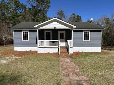 Charming single-story home with a inviting front porch and landscaped yard at 415 Circle Dr., Johnsonville, SC 29555