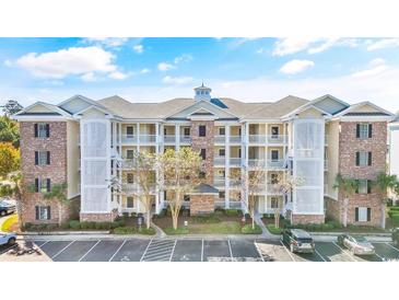 Beautiful three-story condo building with multiple balconies and ample parking at 4843 Luster Leaf Circle # 105, Myrtle Beach, SC 29577