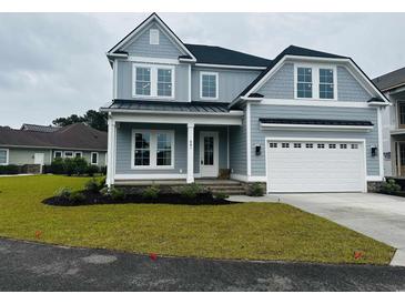 Charming two-story home with a well-manicured lawn, a two-car garage, and a covered front porch at 641 Waterbridge Blvd., Myrtle Beach, SC 29579