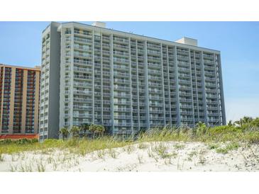 View of the multi-story condo from the beach showcasing its many balconies and beach access at 9820 Queensway Blvd. # 706, Myrtle Beach, SC 29572