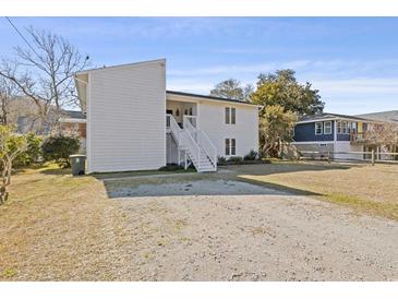 Charming two-story home with white siding and stairs leading to the front entrance at 2005 Havens Dr., North Myrtle Beach, SC 29582