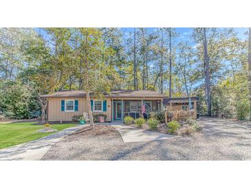 Charming single-story home featuring a screened-in porch and inviting curb appeal at 2166 Marion Circle, Little River, SC 29566