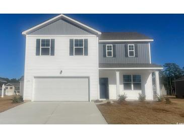 Two-story home with a two-car garage, white siding, gray accents and a well manicured lawn at 335 Glade Ct., Loris, SC 29569