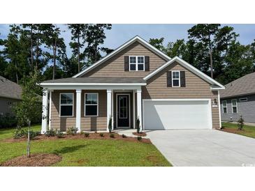 Charming single-Gathering home features a two-car garage, manicured lawn, and inviting front entrance at 402 Clear Lake Dr., Conway, SC 29526