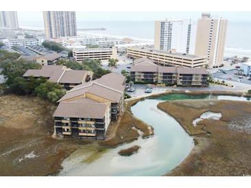 Aerial view of condo complex with water feature and beach access in a popular coastal community at 9501 Shore Dr. # A309, Myrtle Beach, SC 29572