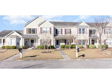 Charming two-story townhouse with well-maintained lawn and complementary maroon shutters at 1155 Harvester Circle # 1155, Myrtle Beach, SC 29579